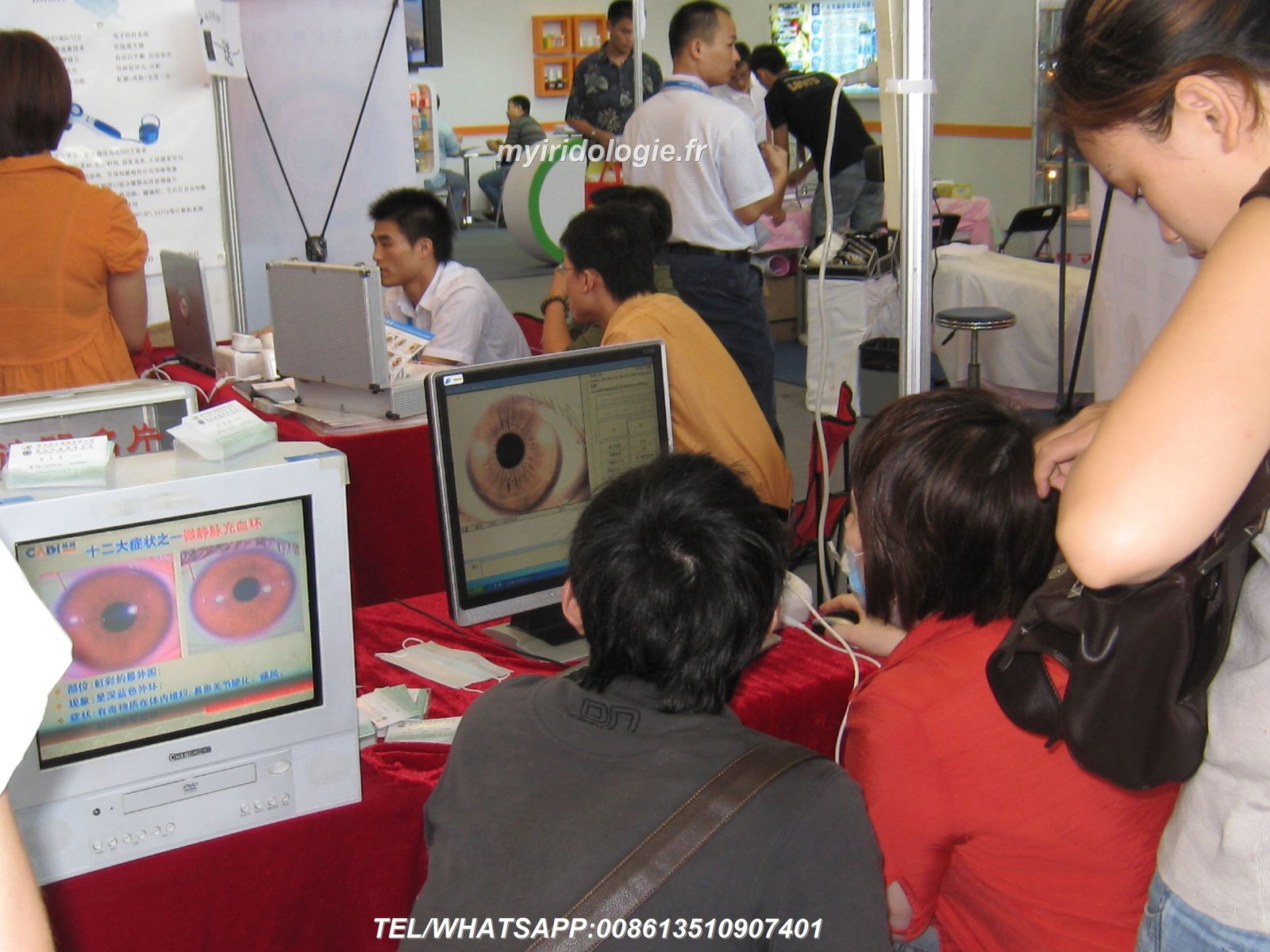 Natural therapy clinic practitioner using iridology camera with patient